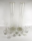 A collection of laboratory glass measuring cylinders. Some with markings to the exteriors, Max.