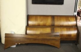 A king size wooden sleigh bed.