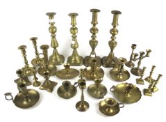 A collection of brass candlesticks. Including some pairs, Max.