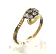 A 9ct gold and diamond six stone cross-over ring.