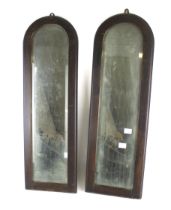 A pair of bevelled edge mahogany framed wall mirrors. With 'arch' tops, 67cm x 21.