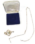 An Edwardian gold and pale-blue garnet-topped-doublet two stone open double-scroll pendant,