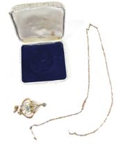 An Edwardian gold and pale-blue garnet-topped-doublet two stone open double-scroll pendant,