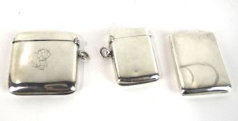 Two silver vesta or match cases and a match book holder.