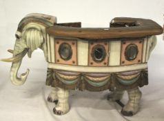 A vintage Indian carnival merry go round ride on elephant prop.