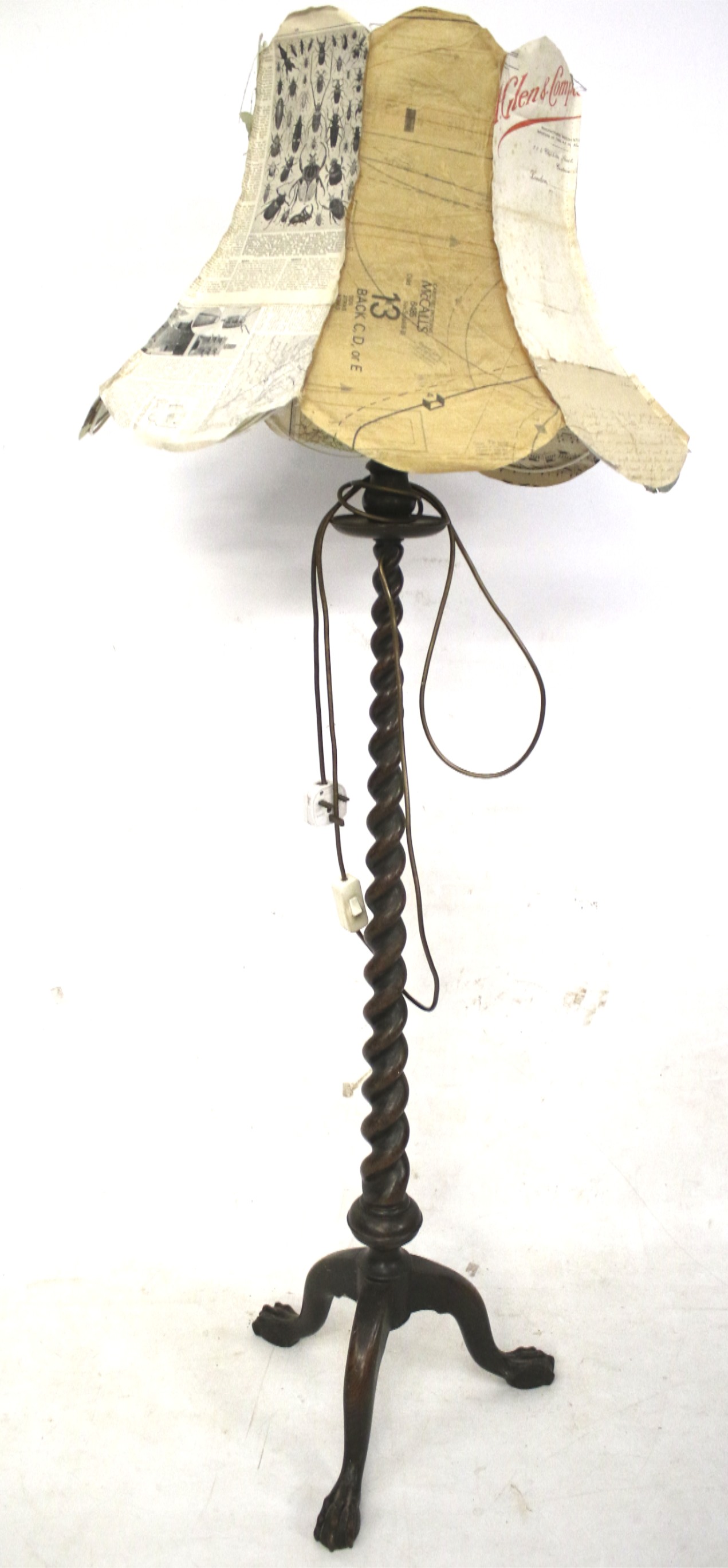 A vintage barley twist tripod standard lamp with ball and claw feet.