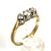 A vintage 9ct gold and diamond three stone ring. The graduated round brilliant diamonds approx. 0.