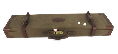 A leather bound canvas shot gun case.