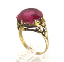 A far Eastern synthetic ruby single stone ring. The round stone approx.