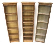 A near set of three freestanding bookcases.