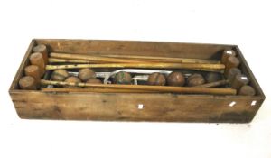 A vintage croquet set in a wooden crate.