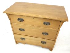 A satin walnut chest of drawers.
