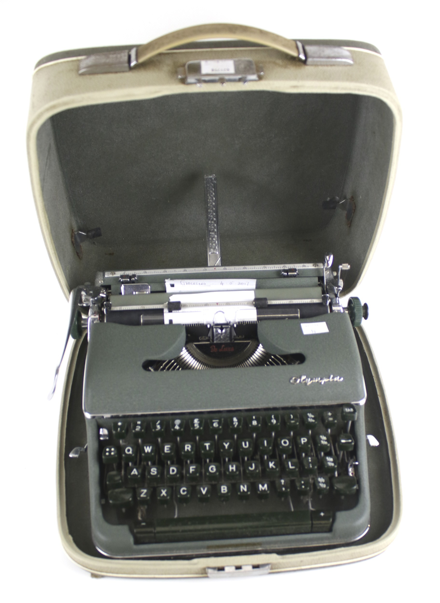 An Olympia De Luxe portable manual typewriter.