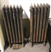 A pair of vintage cast iron hot water radiators.
