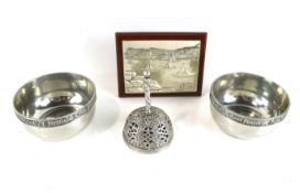 A silver plaque, a pair of silver-plated round bowls and a plated bell.