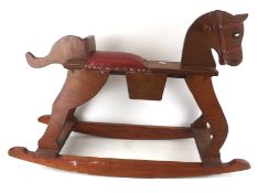 A vintage scratch built plywood rocking horse.