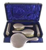 A silver mounted five piece dressing table set.