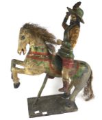 A figure of a man astride a horse, possibly Mexican.