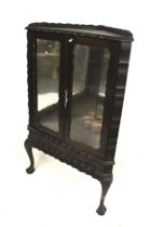 An ebonised Edwardian floor standing corner cabinet.