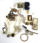 A collection of costume jewellery including a rolled-gold tubular slave bangle;