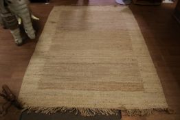 A large coarse woven rug.