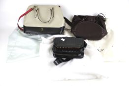 Three contemporary women's handbags.