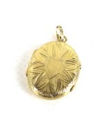 A Victorian gold oval locket. Decorated with a geometric pattern. The bale stamped '18ct', approx.