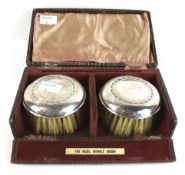 A pair of silver mounted round 'Hazel Shingle brushes'.