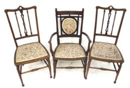 A pair of early 20th century mahogany inlaid chairs and an open armchair.