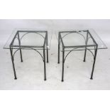 A pair of metal framed and glass top coffee tables.