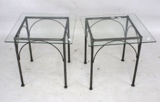 A pair of metal framed and glass top coffee tables.