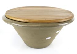 A vintage stoneware bowl with wooden lid. The bowl of tapered form, H23cm x Diameter 44.