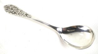 A Continental white metal small spoon.