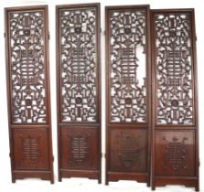 An Oriental hardwood four panel screen. With pierced decoration.