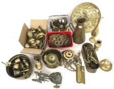 An assortment of brassware. Including horse brasses, a jug and bells, etc. Max.