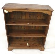 A stained pine freestanding bookcase.