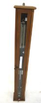 A 20th century school barometer. Contained within a glazed wooden framed case, (AF).