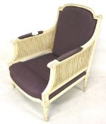 A contemporary white painted bergere rattan style armchair With purple upholstered back and seat.