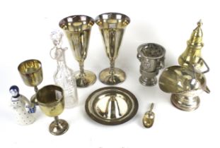 A small collection of plated items including a scuttle shaped sugar bowl and scoop.