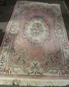 A Chinese style pink wool rug.