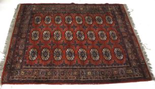 A vintage Persian style red wool rug. With geometric boarder and decoration.