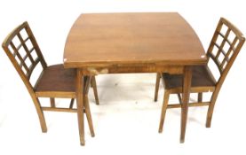 A Mid century extending dining table and a pair of chairs.