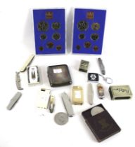 A silver concave oblong cigarette case and other items.