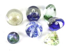 Seven glass paperweights. Including ones by Langham, Anglesey, etc.