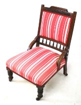 An Edwardian wooden framed chair.