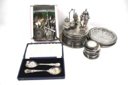 A collection of silver-plate including twelve place mats and a stand.