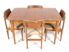 A mid-century extending dining table and a set of four chairs.