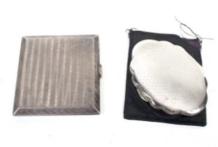 A silver engine turned cigarette case and a Kigu silver shaped-oval compact.