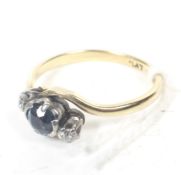 A vintage gold, sapphire and diamond three stone cross-over ring.