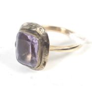 A vintage gold and pale amethyst single stone ring.